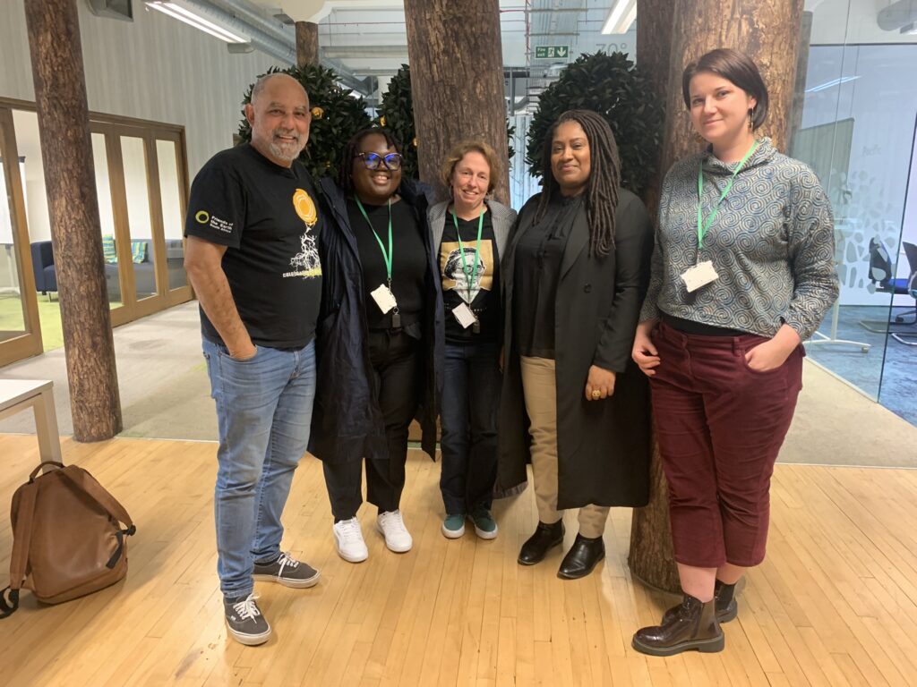 Bell standing with South African climate campaigners at the Friends of the Earth headquarters.