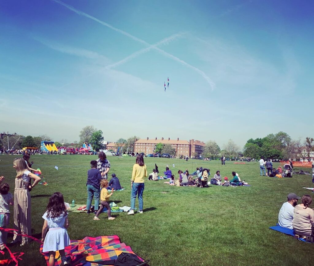 People mill around on Streatham Common watching the Kite Festival.