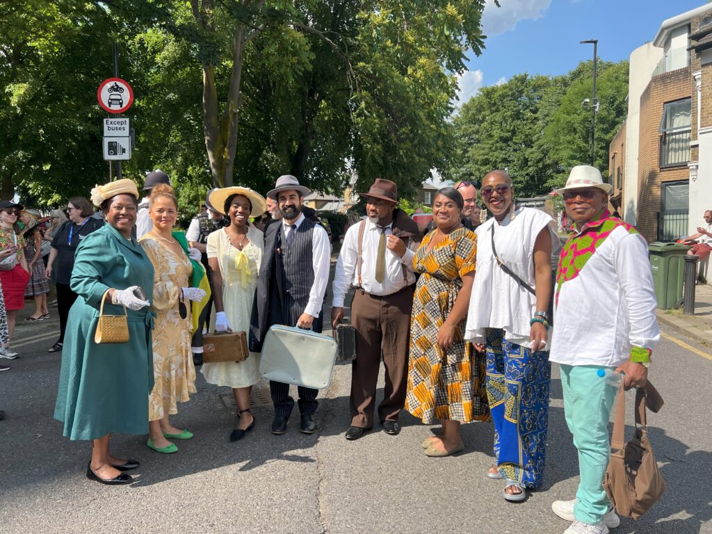 Bell with Cllrs Jacqui Dyer, Donatus Anyanwu, and a group of people wearing vintage 1940s and 1950s apparel.