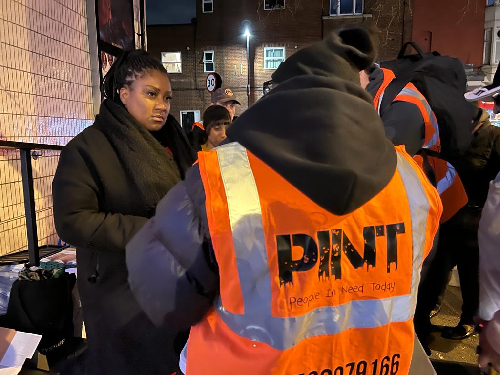 Bell talks to a PINT Giving Volunteer outside Streatham Odeon