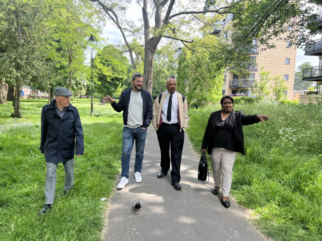 Bell walks up the pathway of Rush Common with Superintendent Cameron and Councillors Adrian Garden and Ben Kind (Brixton Rush Common).