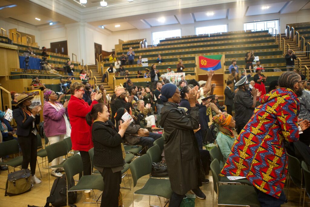 Reparations Conference attendees applaud
