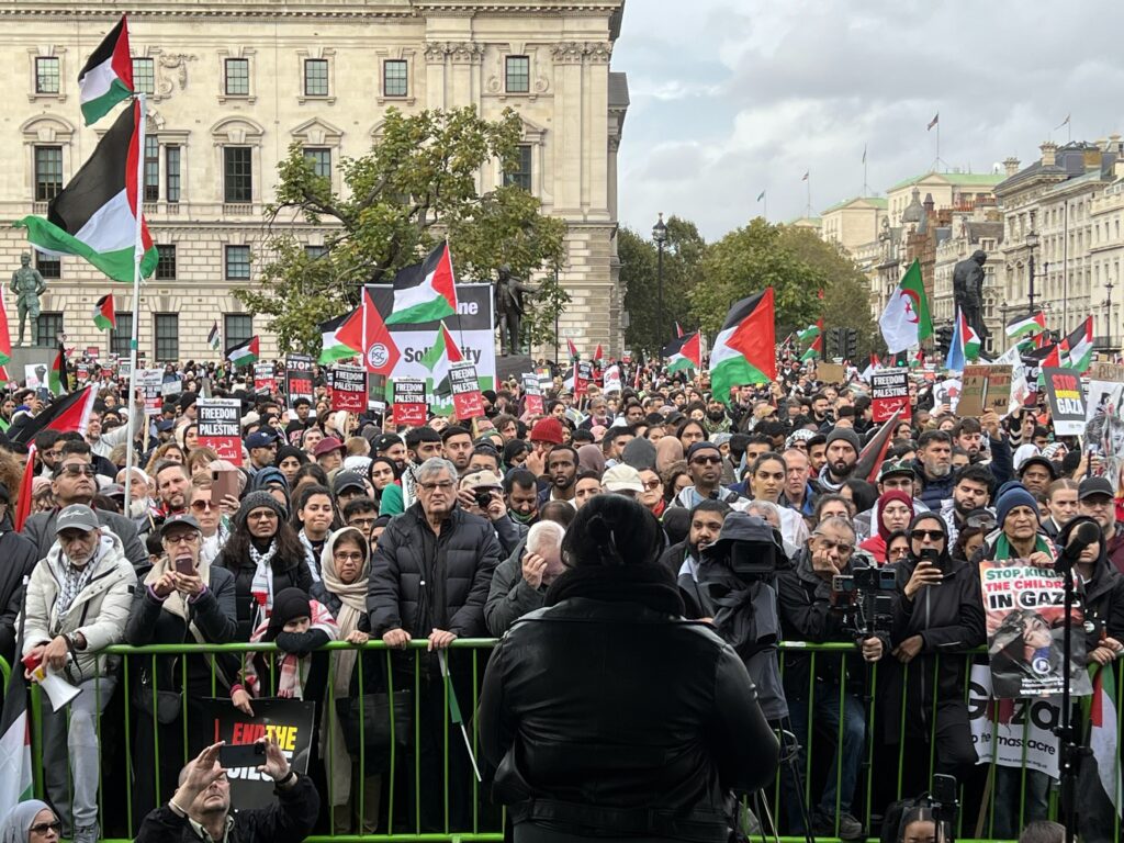 Bell addresses a crowd of demonstrators at a Ceasefire Rally in Parliament Square