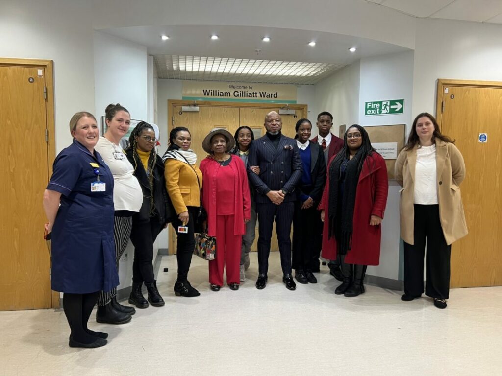 Bell stands in the William Gilliat Ward at King’s College Hospital with staff and Peace's family for the official opening of the new bereavement suite yesterday.
